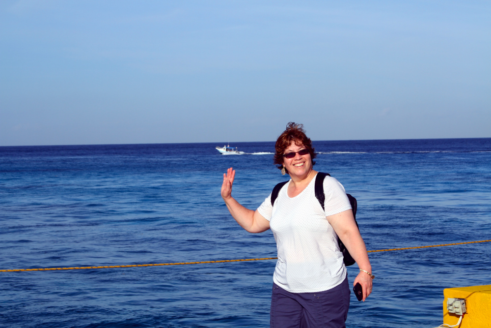 Maria by the ocean reflects the ease and balance found in exploring different types of somatic exercises, showing how movement and awareness bring freedom and connection. Maria waves by the ocean, symbolizing joy, balance, and presence—capturing the freedom and connection that can come from exploring different types of somatic exercises.