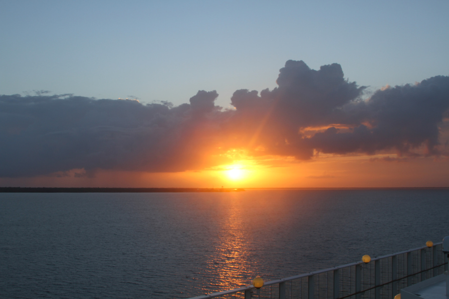 Peaceful sunset over the ocean capturing the essence of what is Somatic awareness—a reminder to pause, notice, and reconnect with the present moment. Sunset over calm ocean waters with golden light breaking through clouds, symbolizing reflection, presence, and what is Somatic awareness in daily life.