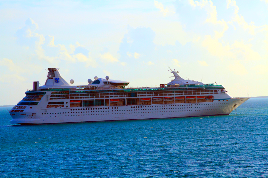 White cruise ship gliding across calm blue sea beneath a bright sky, used as a visual metaphor to explain what is somatic yoga—movement, balance, and inner awareness.